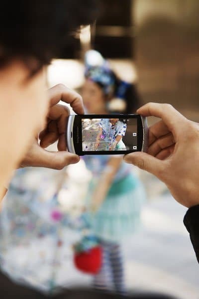 Sony Ericsson Vivaz held in hands with screen active, displaying a map application