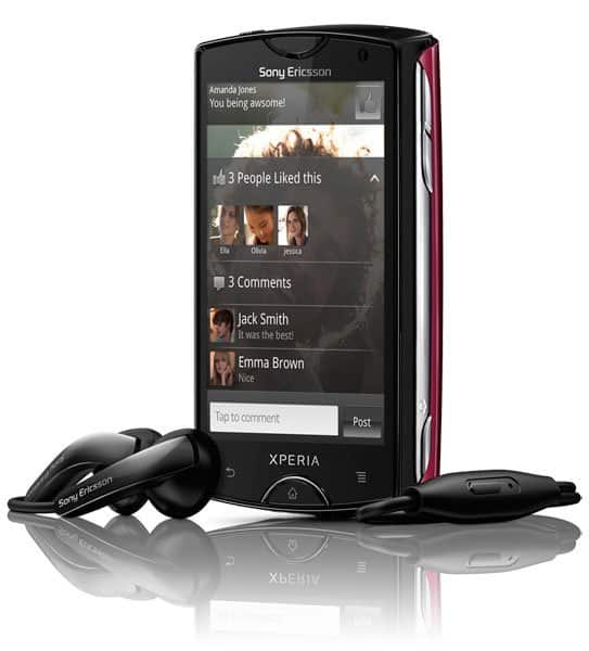Sony Ericsson Xperia Mini phone displayed front-on with screen showing social media feed, accompanied by black headphones