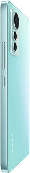 Xiaomi 12 Lite in light blue shown from rear side angle, displaying triple cameras, side buttons, and Xiaomi logo at the bottom.