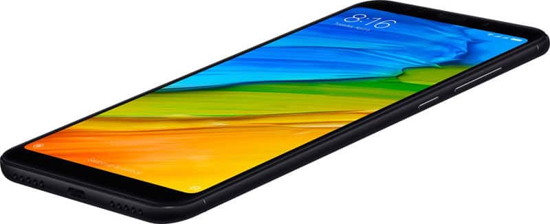 Xiaomi Redmi Note 5 in black, front display lit at 8:16, low angle view shows right-side buttons and bottom USB port.