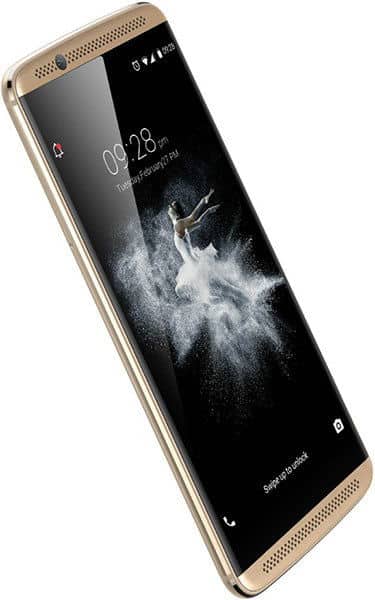 ZTE Axon 7 front view with screen on, showing time 10:28 and lock screen graphics, gold frame with speaker grilles at top and bottom