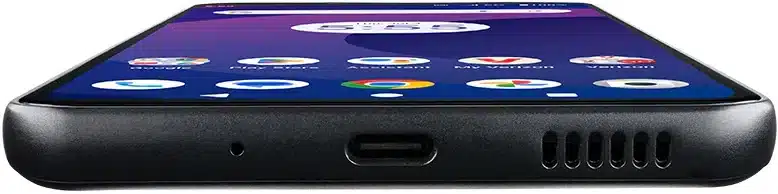 Orbic Trophy 5G smartphone, bottom edge view showing charging port and speaker grille against dark background with home screen visible